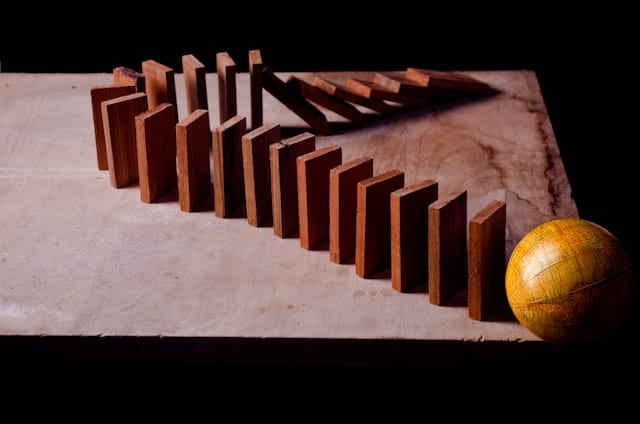Wooden dominos arranged on surface.