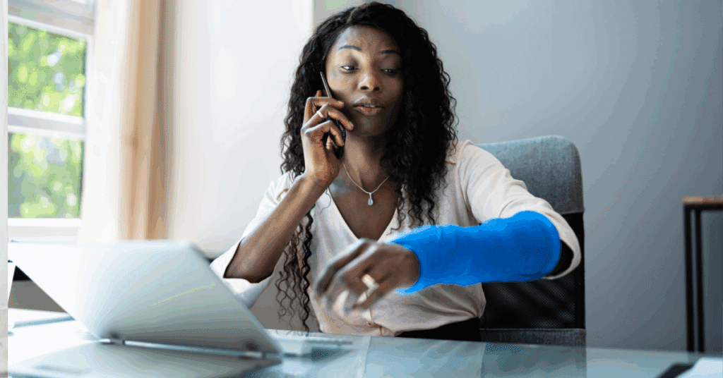 Woman at work with arm in sling