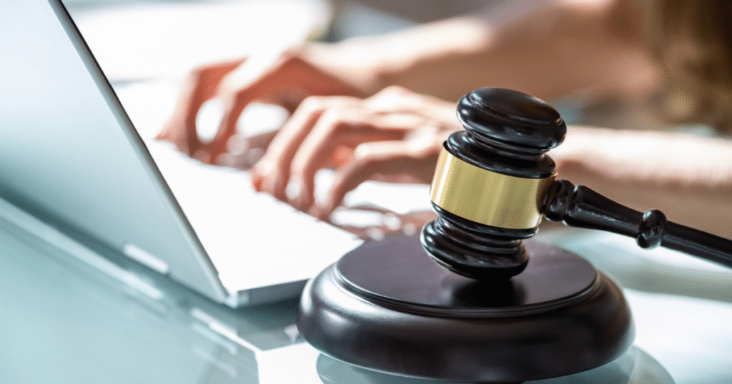 Gavel beside a laptop, illustrating a workers' comp policy cancellation court ruling